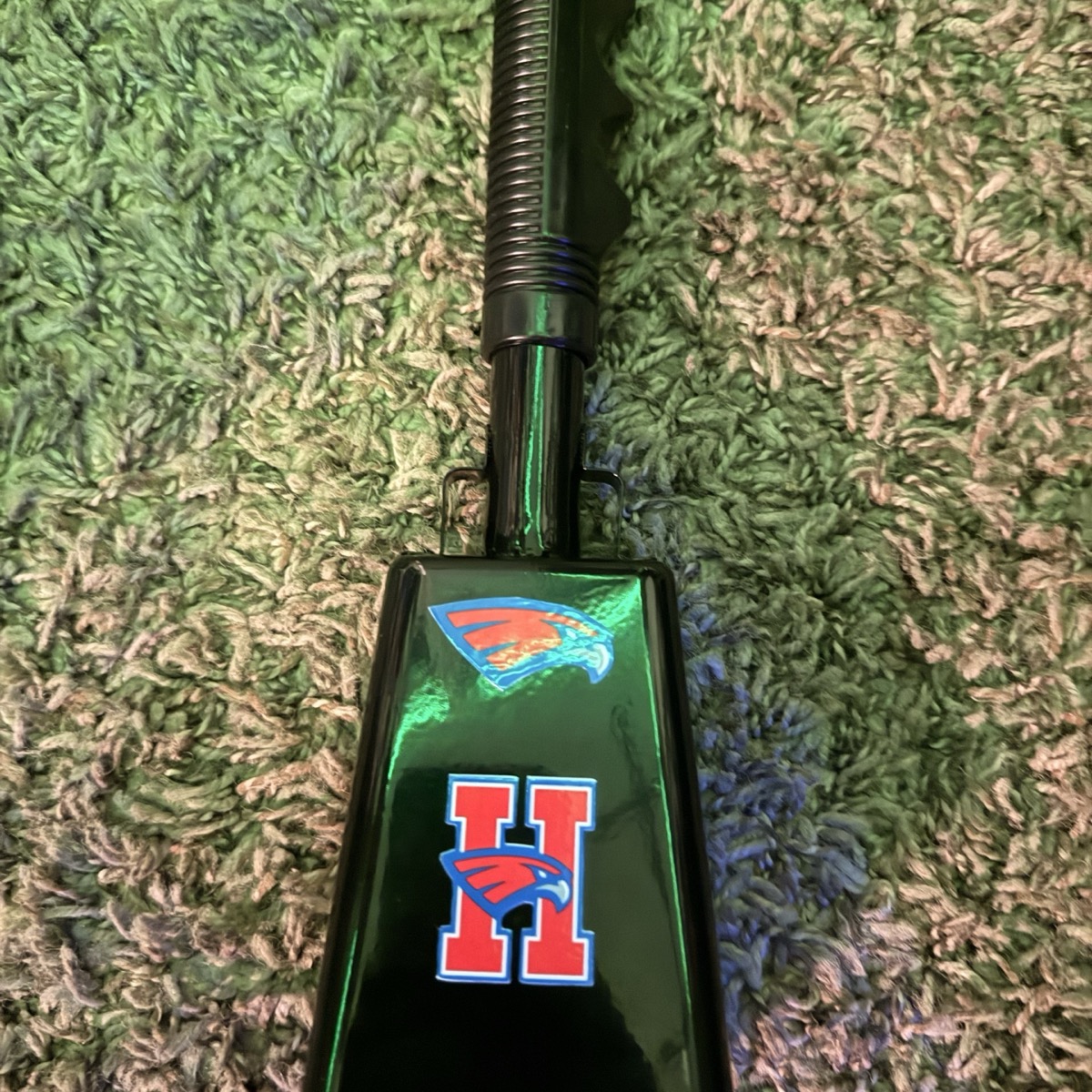 Black Hays Hawks cowbell with red, white and blue school-logo graphics.
